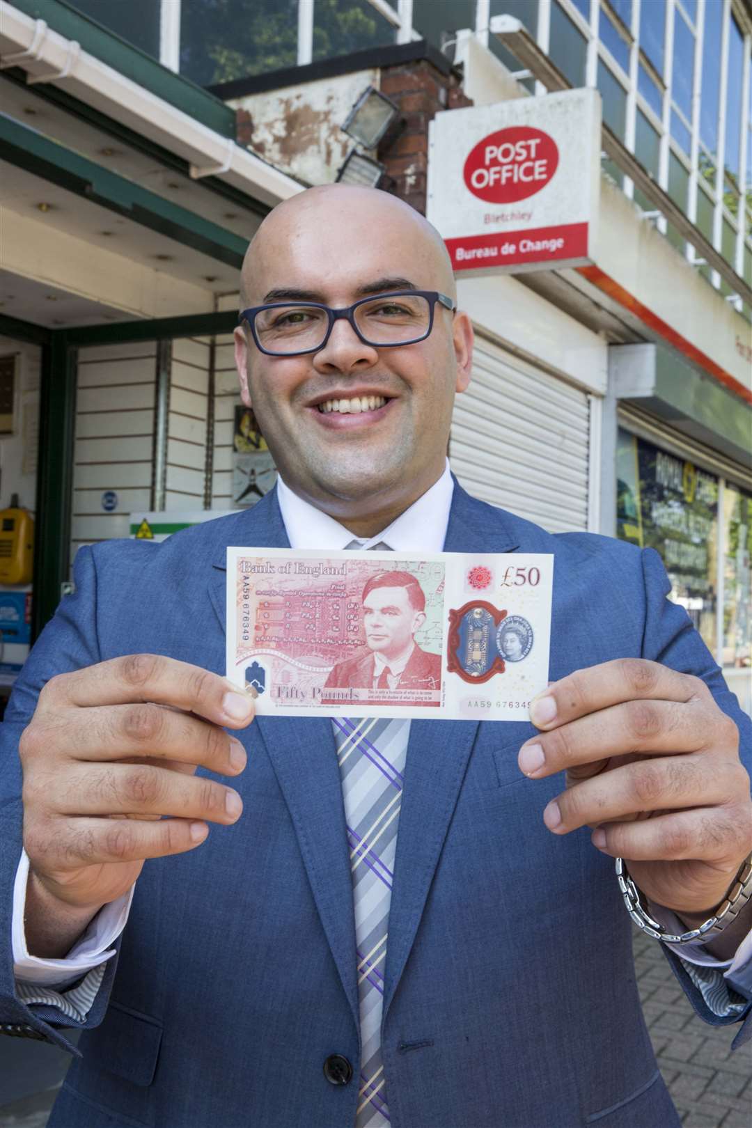 Postmaster Ahmed Butt holding the new £50 banknote (Post Office/PA)