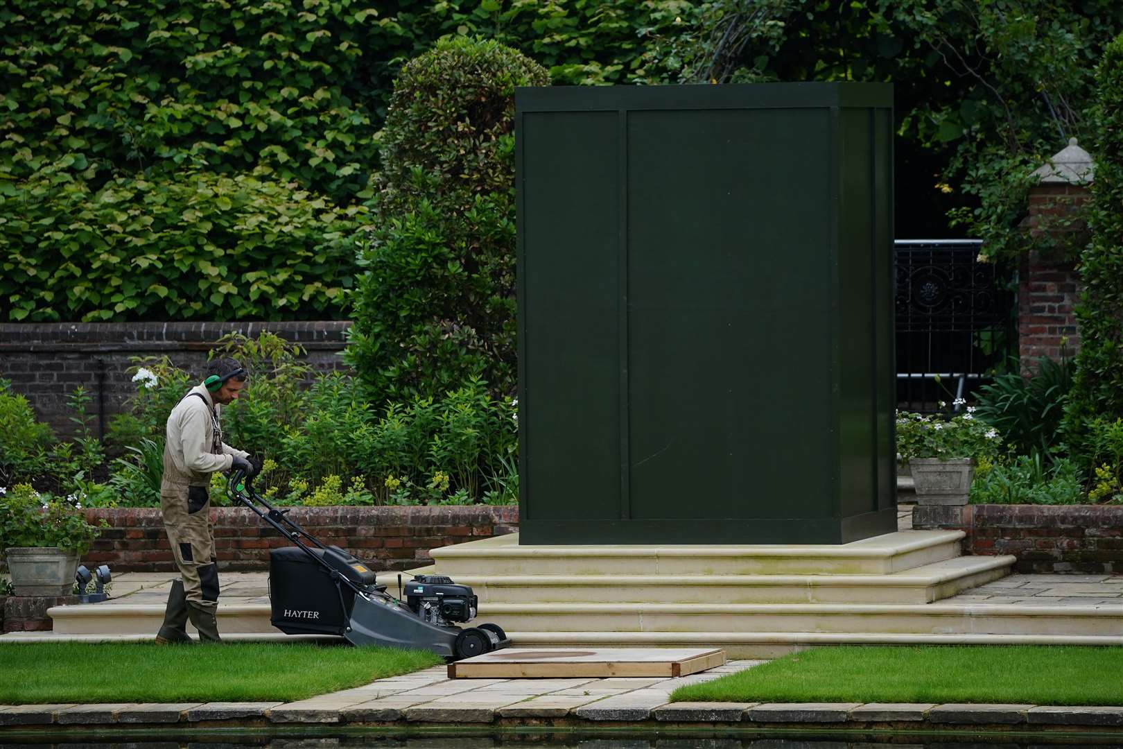 The covered statue ready for its unveiling (Aaron Chown/PA)