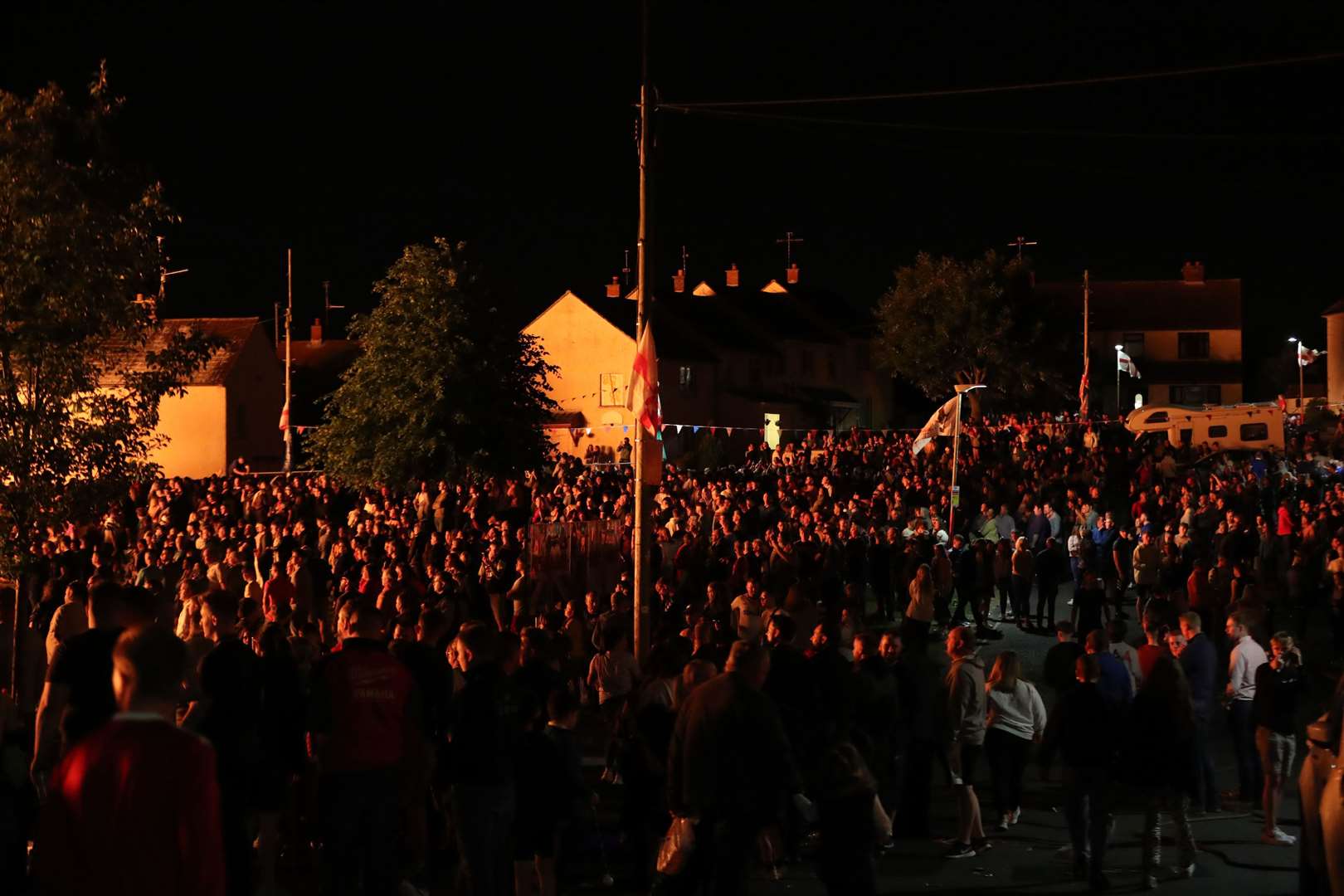 Thousands watch as a huge bonfire in the loyalist Corcrain area of Portadown, Co Armagh, is lit to usher in the Twelfth commemorations (Niall Carson/PA)