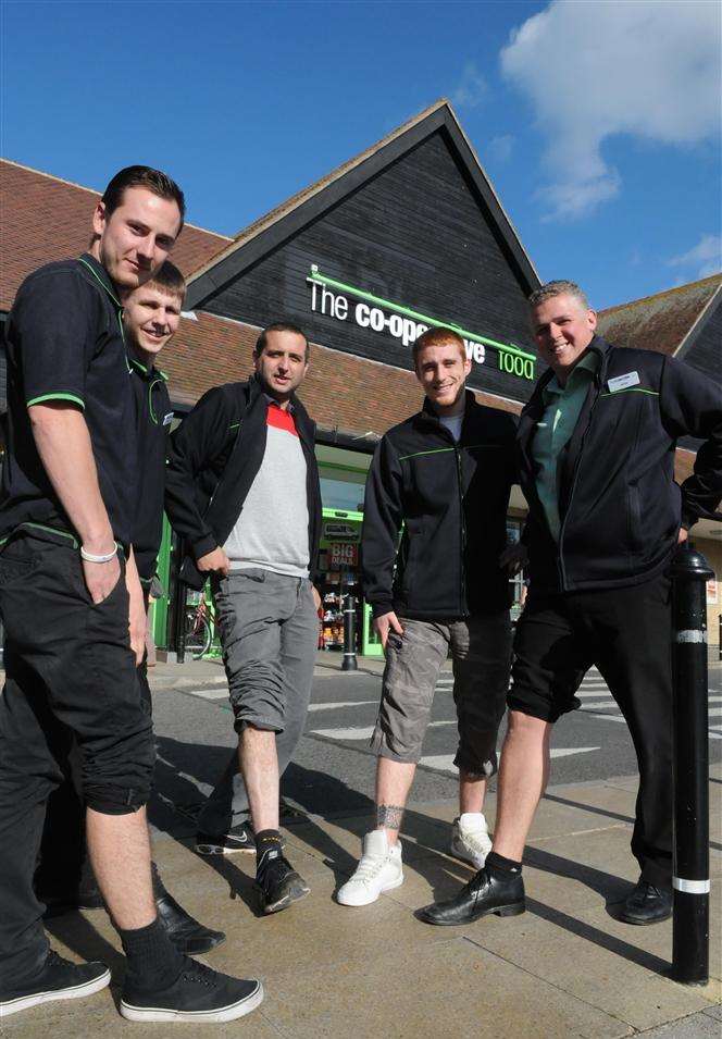 Members of staff at the Sandwich Co-Op rolling up their trouser legs for a photo call as the team is raising cash at a leg wax to buy the elderly people at The Centre, Sandwich, a Christmas meal