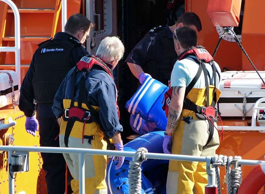 Photo by Kent 999. Border Force officers examine the blue rubber dinghy used by a Mongolian man.