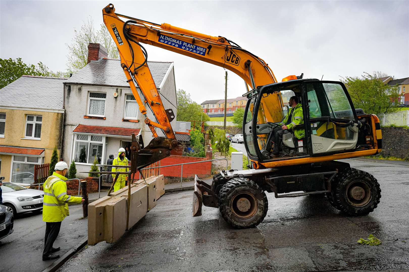 Council contractors place heavy concrete barriers at the top of Waun Wen Road (Ben Birchall/PA)