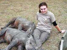 Rachael Pfeiffer relaxes with some baby rhinos