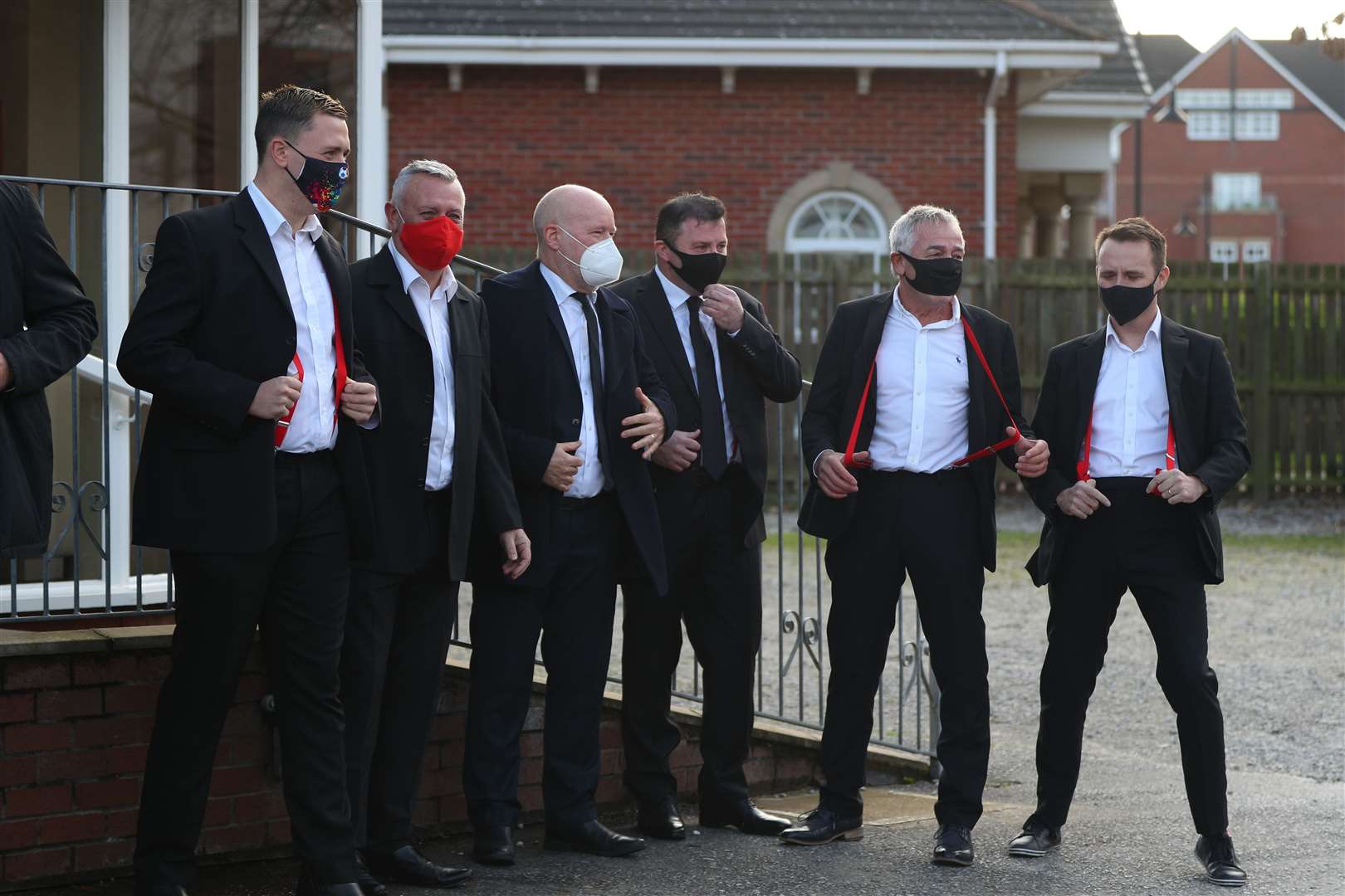 Mourners wearing red braces in honour of Bobby Ball (Peter Byrne/PA)