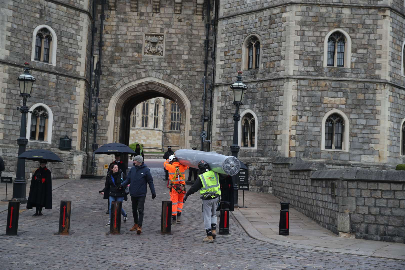 Workmen carry a roll of matting through the Henry VIII Gate at Windsor Castle as preparations gather pace for Saturday (Steve Parsons/PA)