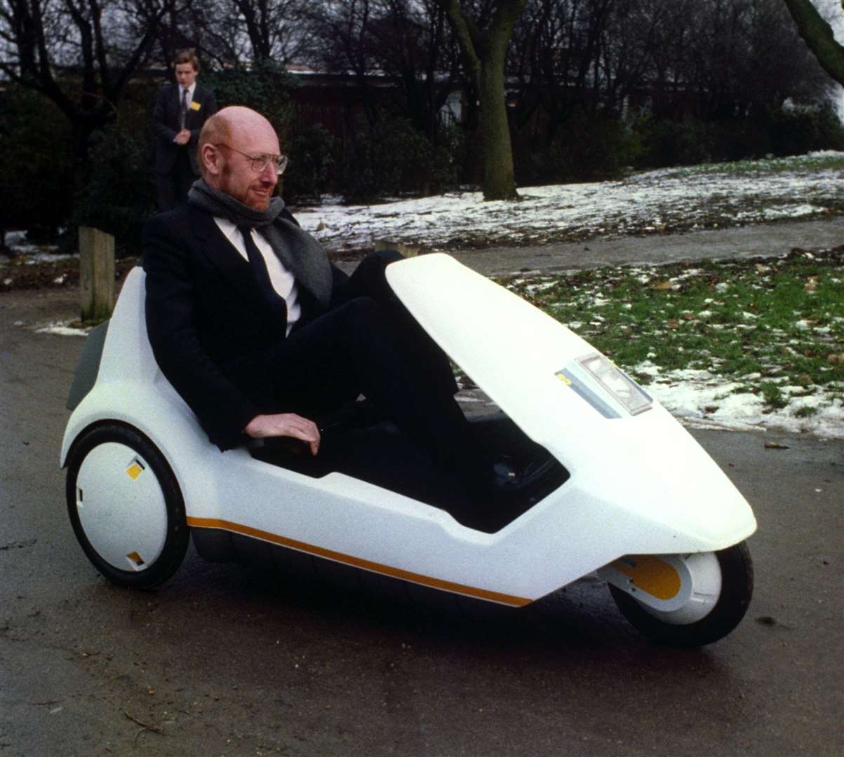 Inventor Sir Clive Sinclair demonstrates his battery-assisted pedal-powered tricycle (PA)