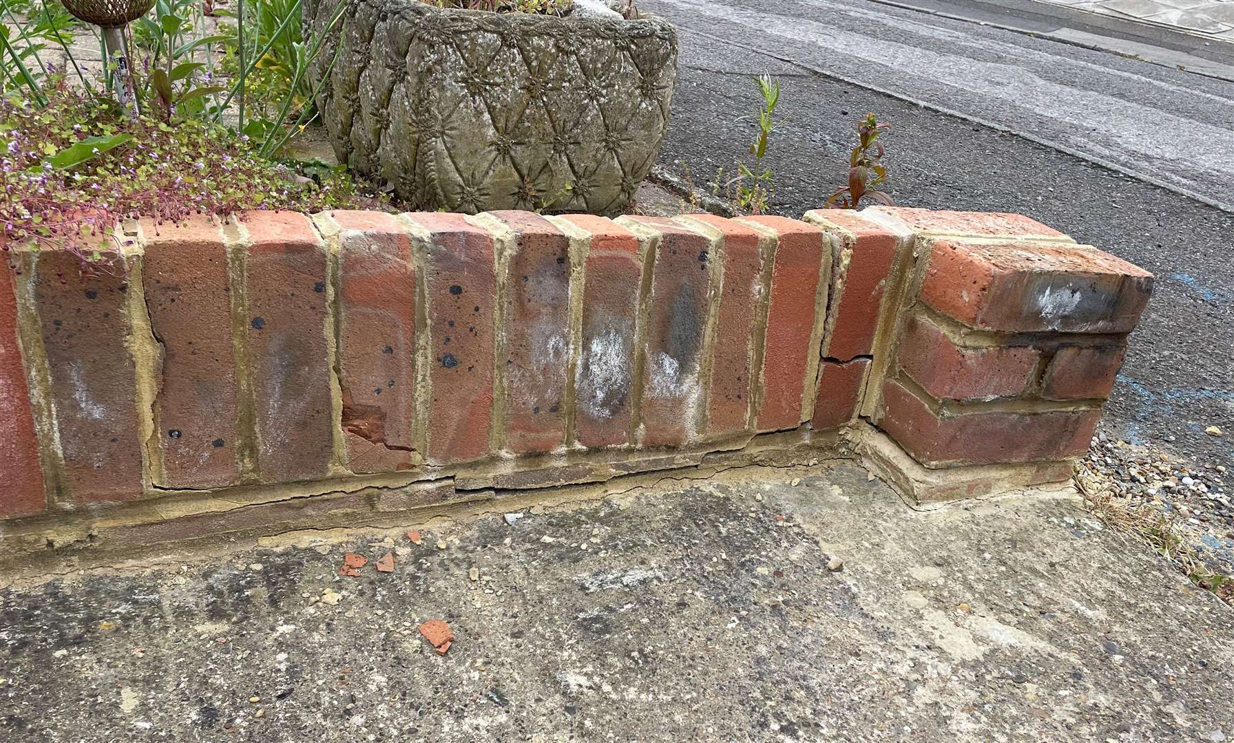 The broken wall which the carer knocked over