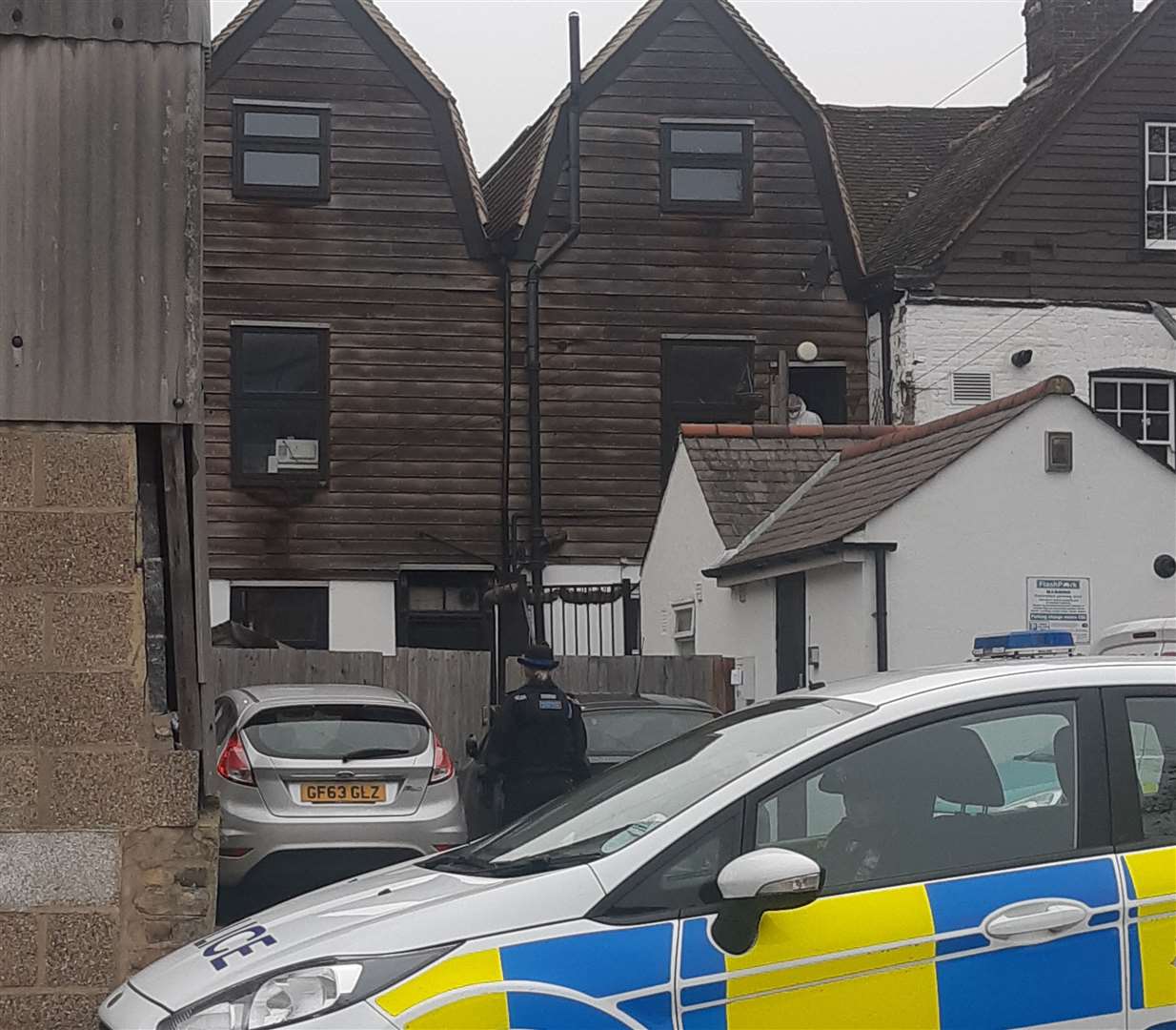 A forensic officer coming out of a property in Almon Place, Rochester