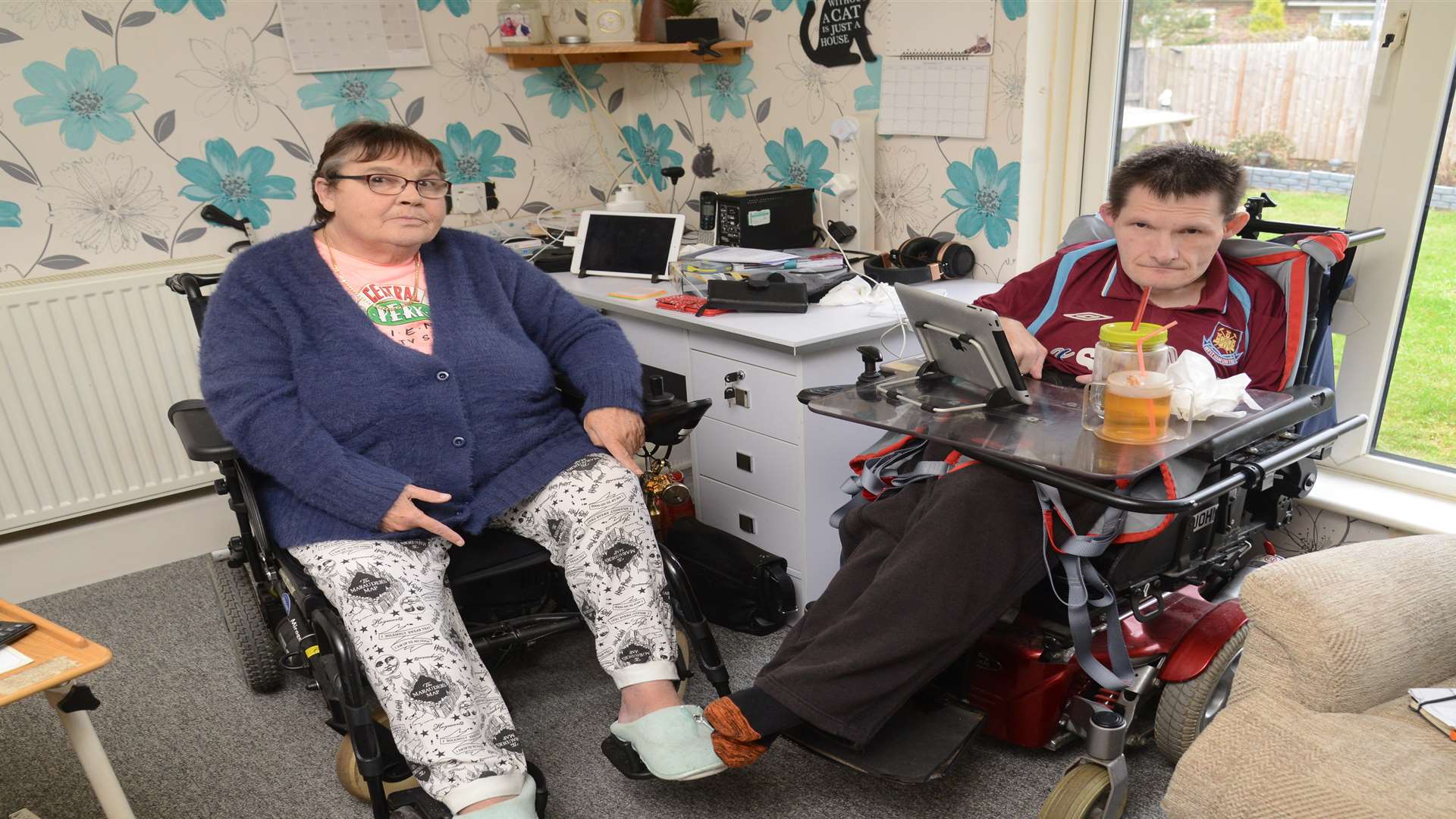 Rosemary Norris and her son John who have been waiting almost a year for parts for their wheelchairs