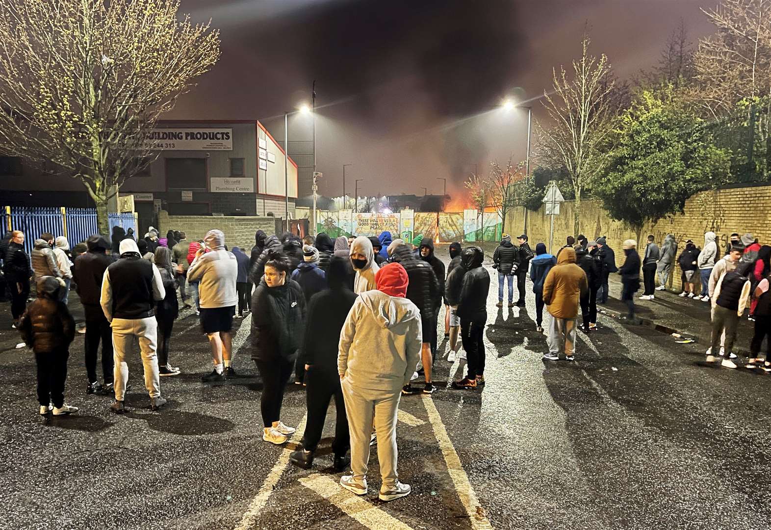 People gather by the Peace Gates in Lanark Way, Belfast, during unrest last month (Liam McBurney/PA)