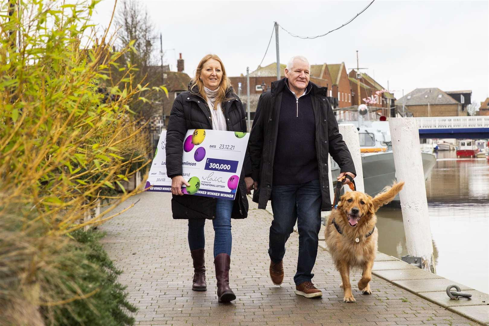 Louisa and Greg Tomlinson with their beloved golden retriever, Teddy. Picture: James Robinson/Camelot