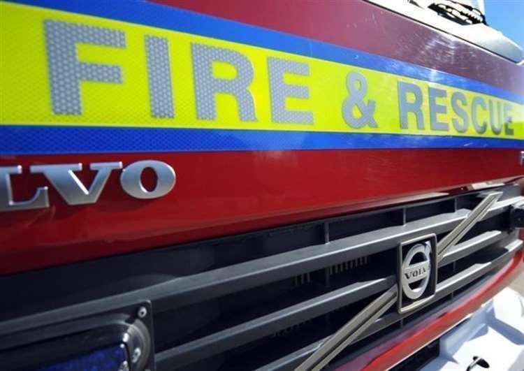 Firefighters put out a blaze in a flat. Stock photo