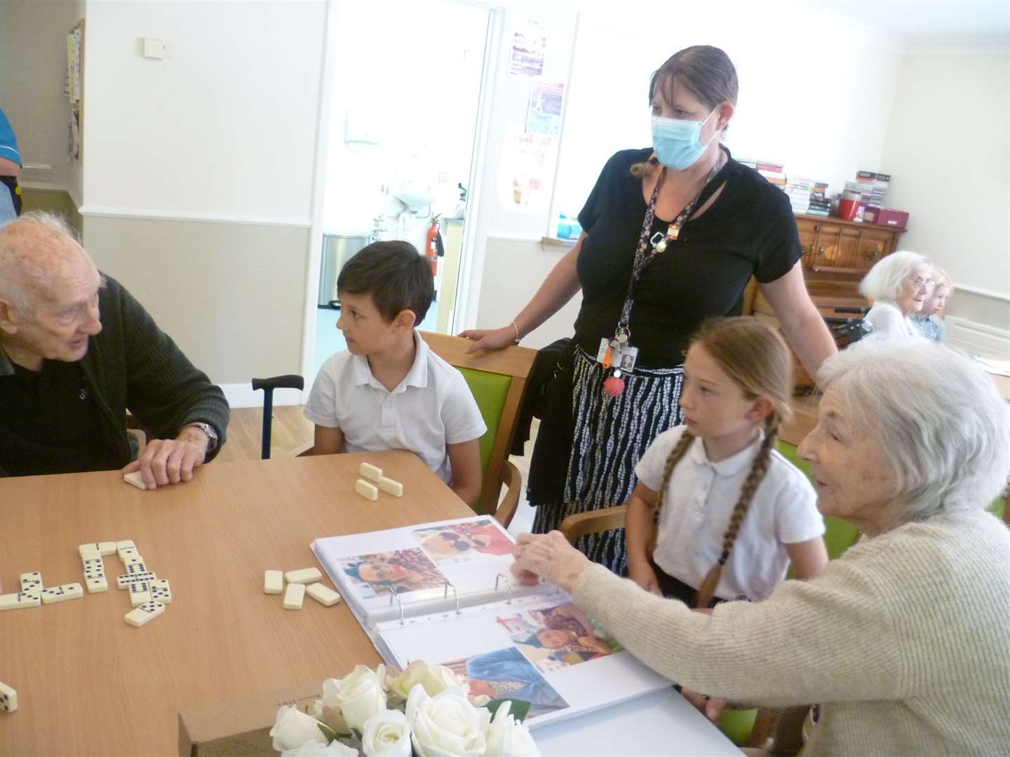 Roman, Willow, Mrs Smith – a teacher at the school – with care home residents (Joanne Bardgett/PA)