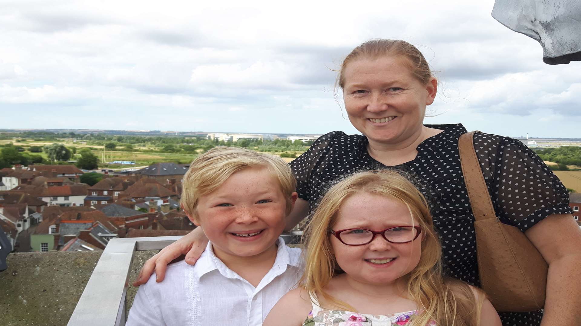 Youngsters Daniel Watkins, seven, and Amy Watkins, nine, - with mum Sue - spotted their school from the top of the tower