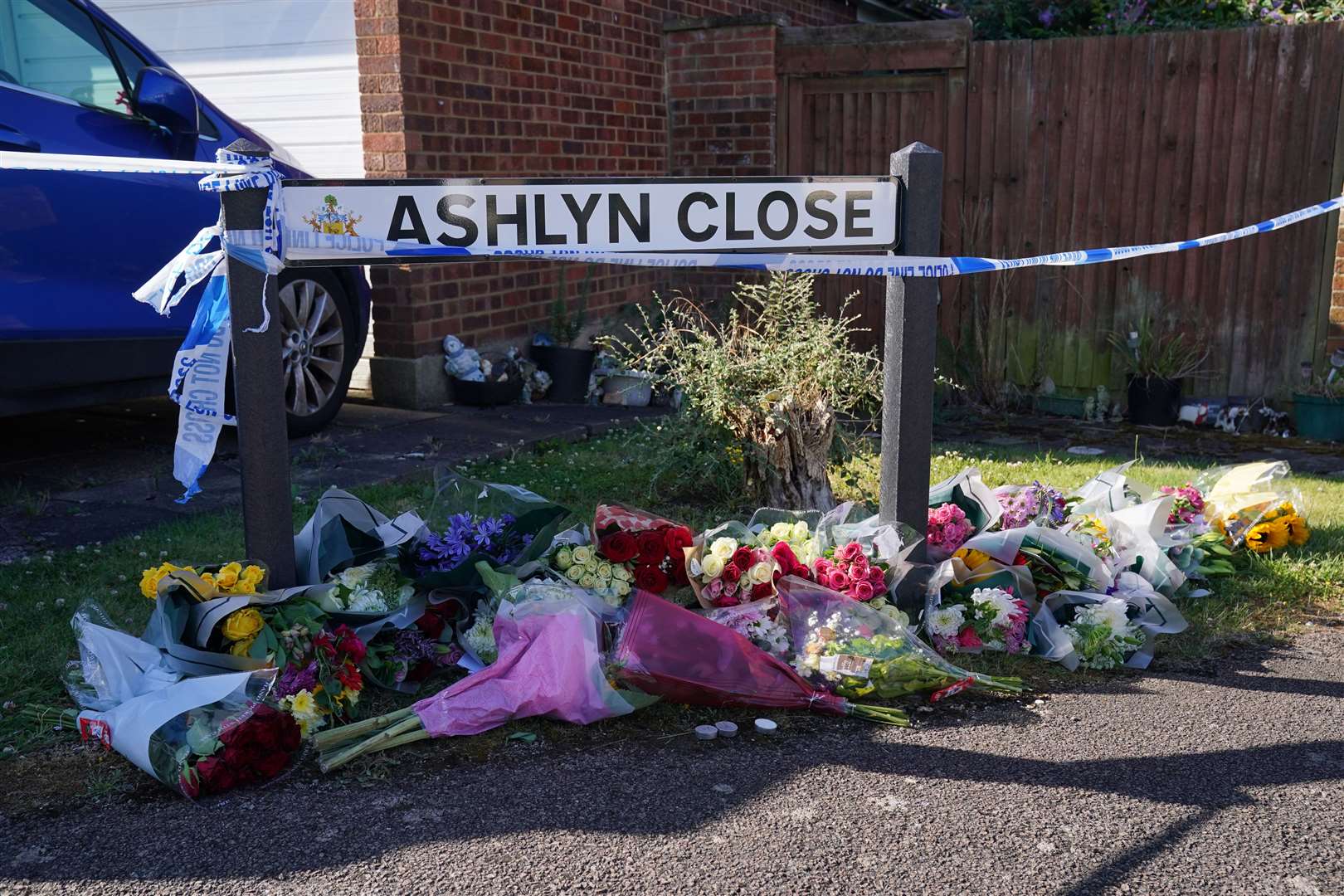 Floral tributes near the scene in Ashlyn Close, Bushey, Hertfordshire (Jonathan Brady/PA)