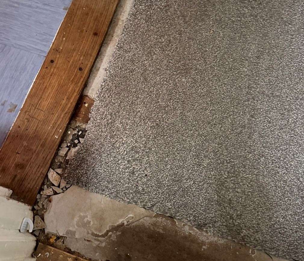 The broken tiles underneath the hallway floor at the flat in Willington Street, Maidstone