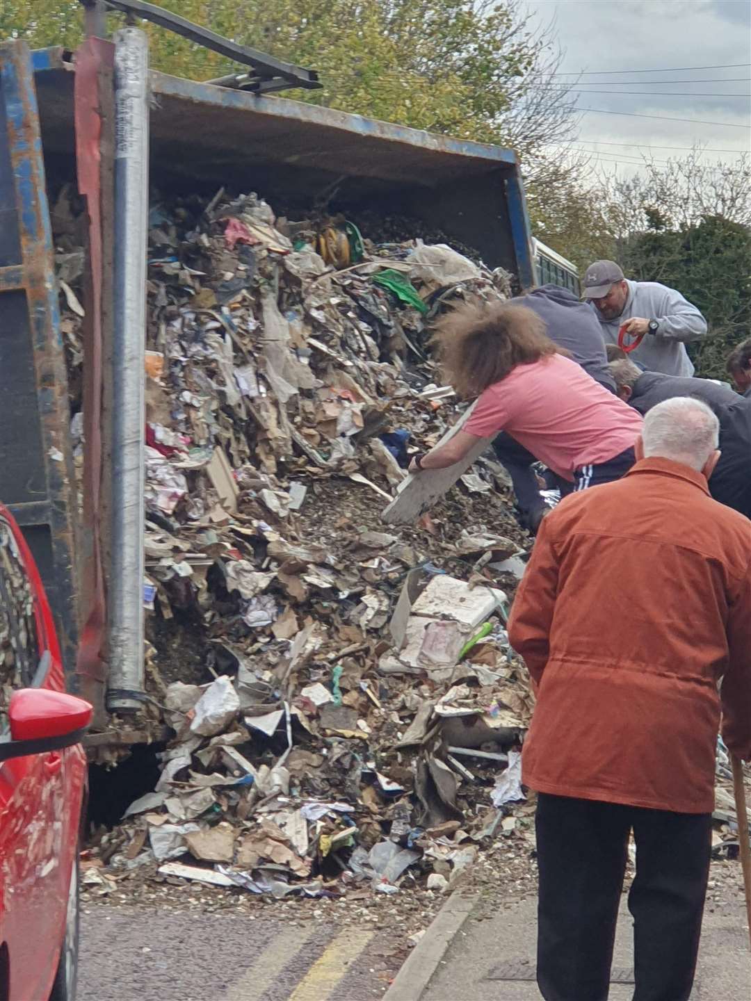 Passers-by rushed to the scene after the lorry tipped over. Picture: Clint Else