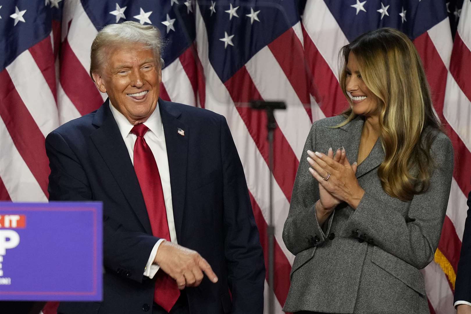 A jubilant Donald Trump dances as Melania Trump looks on (Alex Brandon/AP)