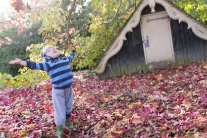Playing in the autumn leaves near the Boathouse at Scotney Castle. Picture: National Trust/John Miller