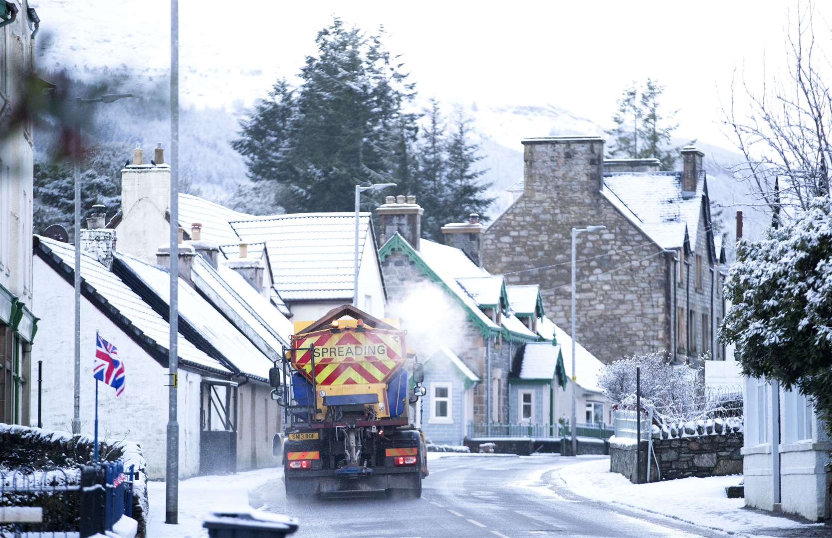 A snow plough spreads grit (Jane Barlow/PA)