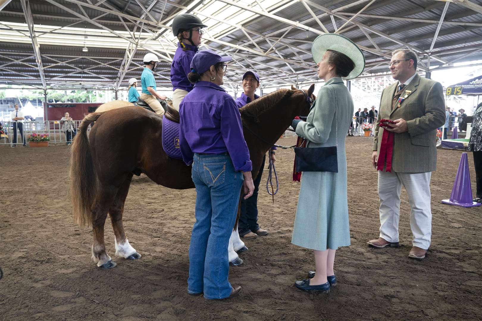 The Princess Royal awards rosettes after watching a display organised by Riding for the Disabled Association (Kirsty O’Connor/PA)