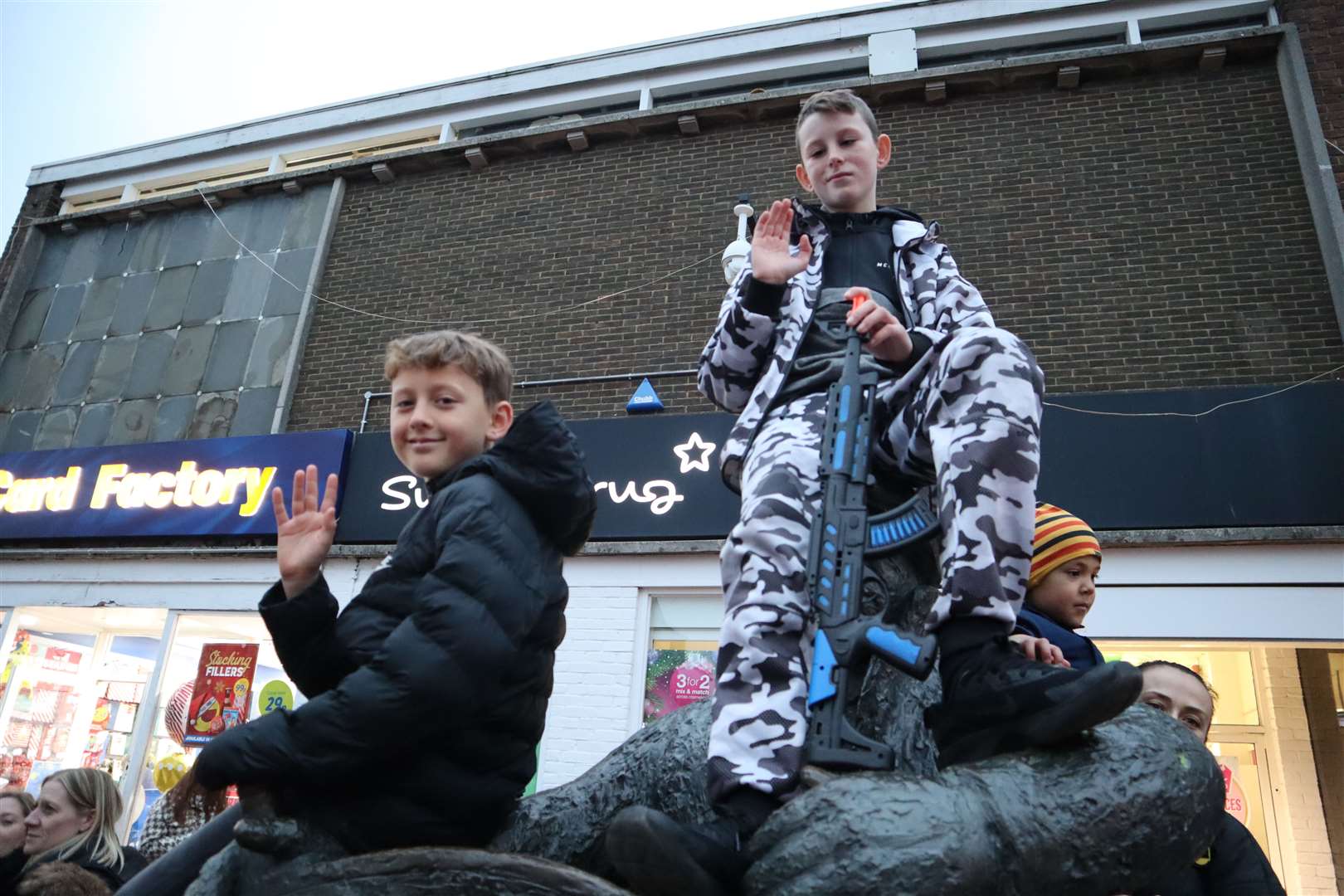 Caleb Viotto, 10, and Keegan Murphy, 11, get a good view from the top of the bargeman statue at the Sittingbourne Christmas lights switch-on