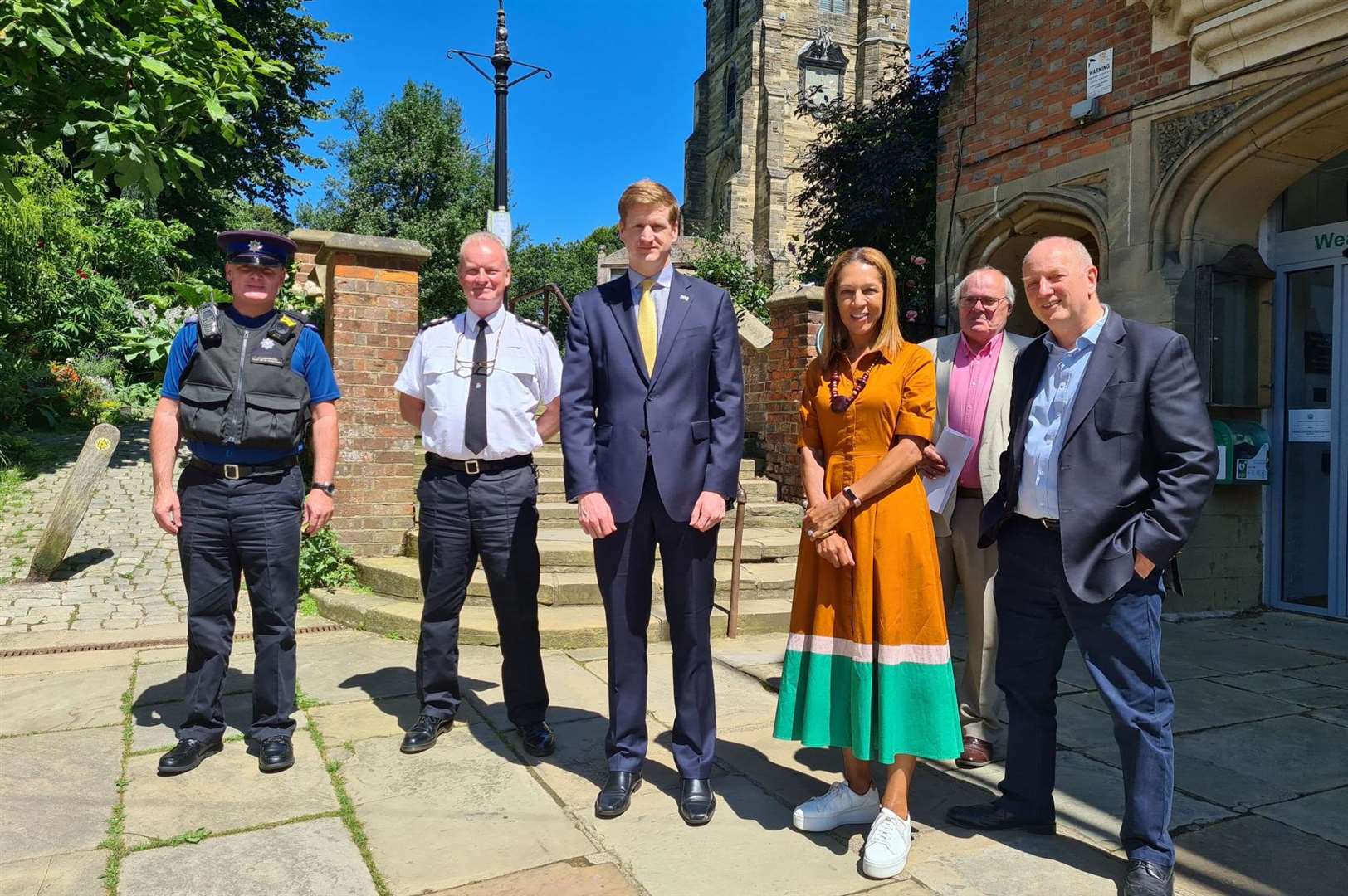 Simon Humphreys, Ian Jones, Matthew Scott, Helen Grant MP, Cllr Tom Dawlings, Cllr Seán Holden outside Cranbrook’s vestry hall