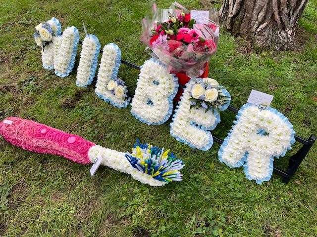 Floral tributes to Wilber including a toothbrush, his favourite sensory item