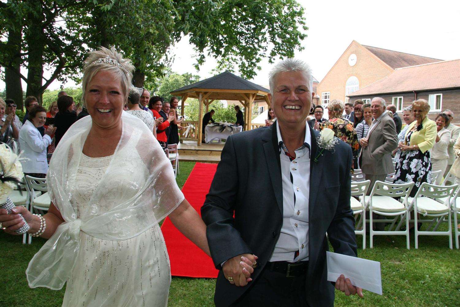 Denise Patterson, left, and Kim Burgess get married at the Tudor Park Marriott Hotel in Maidstone