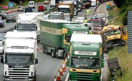 The emergency services battle to free the trapped driver in the yellow-coloured truck. Picture: MATT WALKER