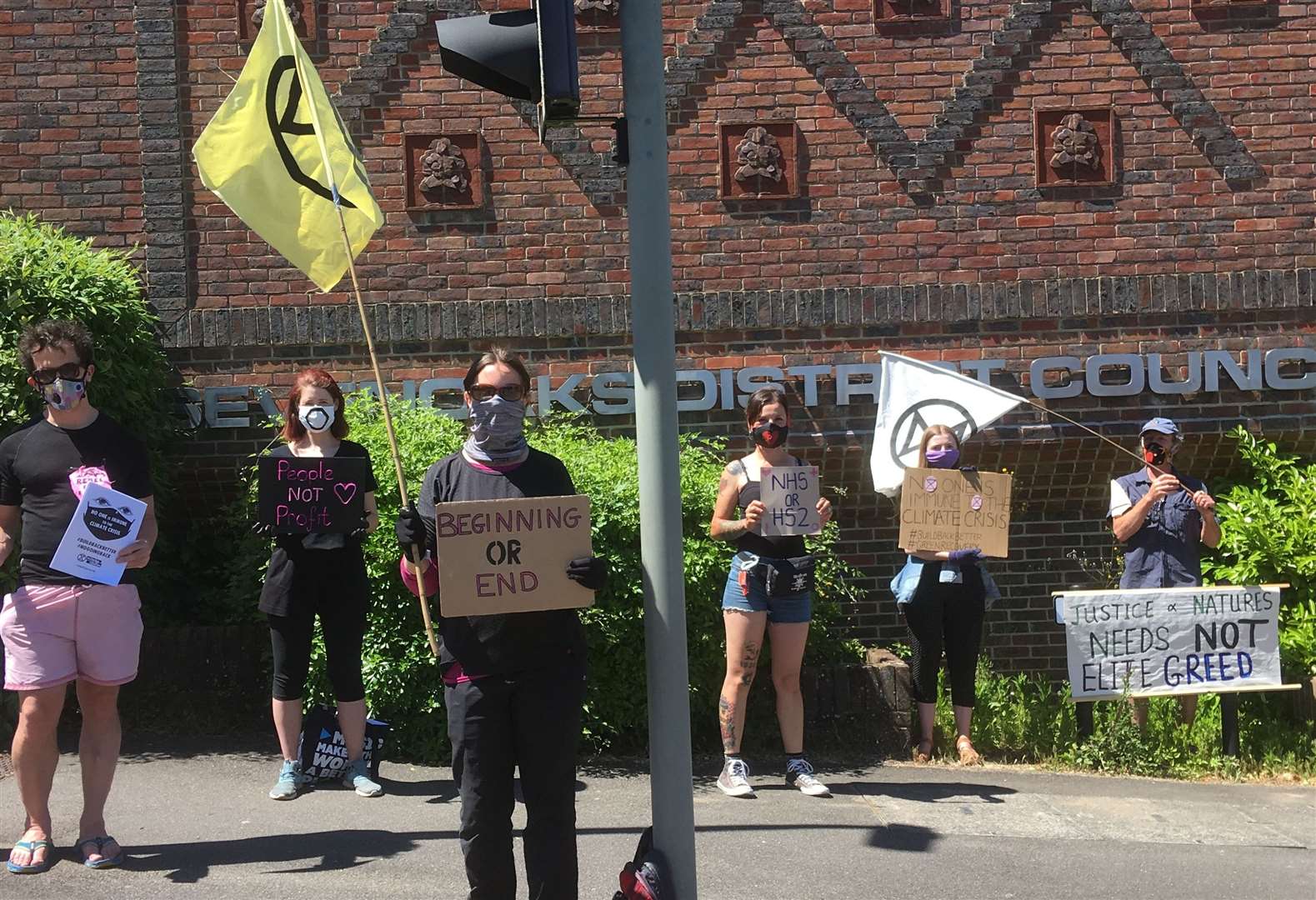 Demonstrators stood silently as they held signs painted with slogans such as "beginning or end"