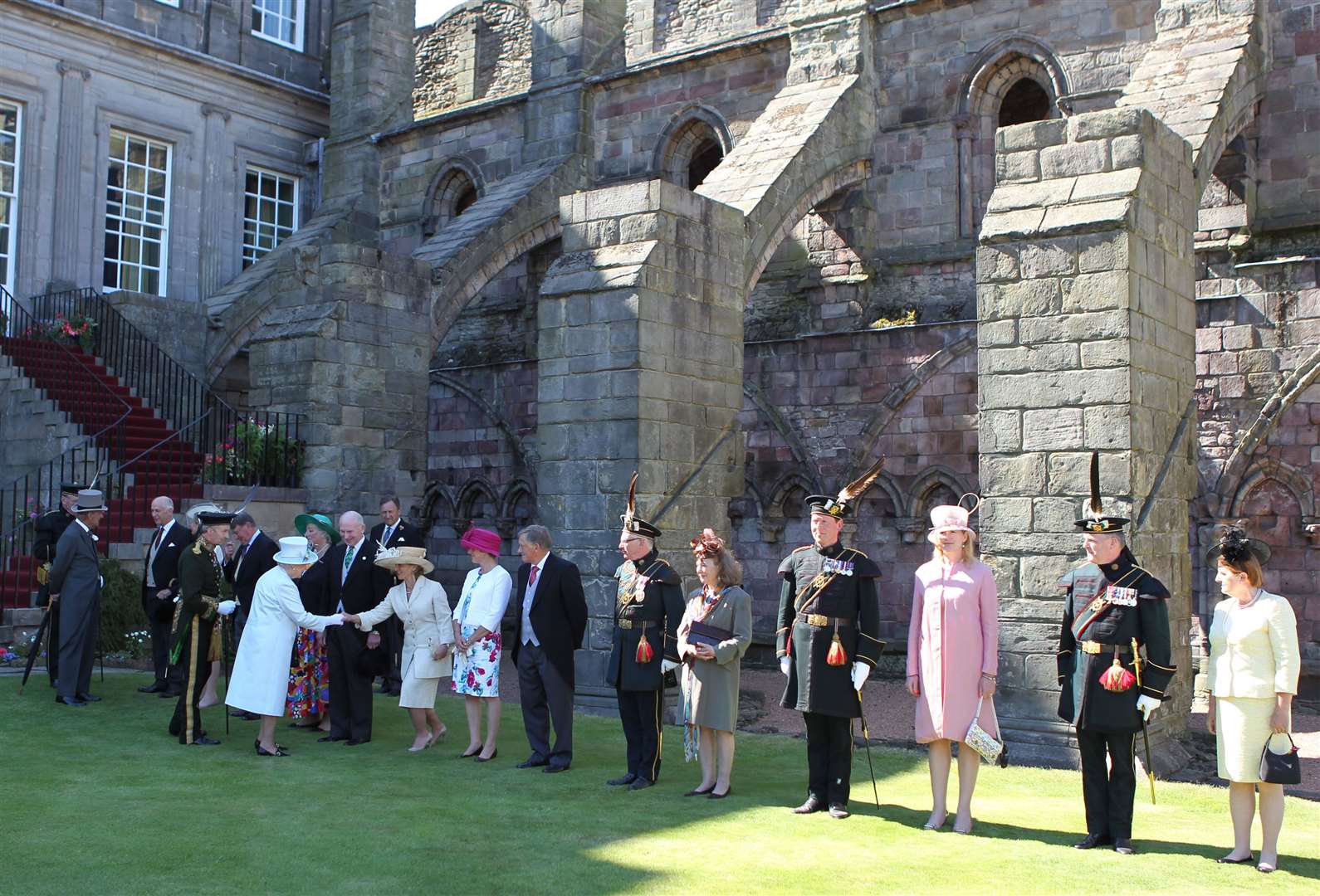 The Queen and Duke of Edinburgh meet guests during a garden party at the Palace of Holyroodhouse in Edinburgh in July 2014 (Andrew Milligan/PA)