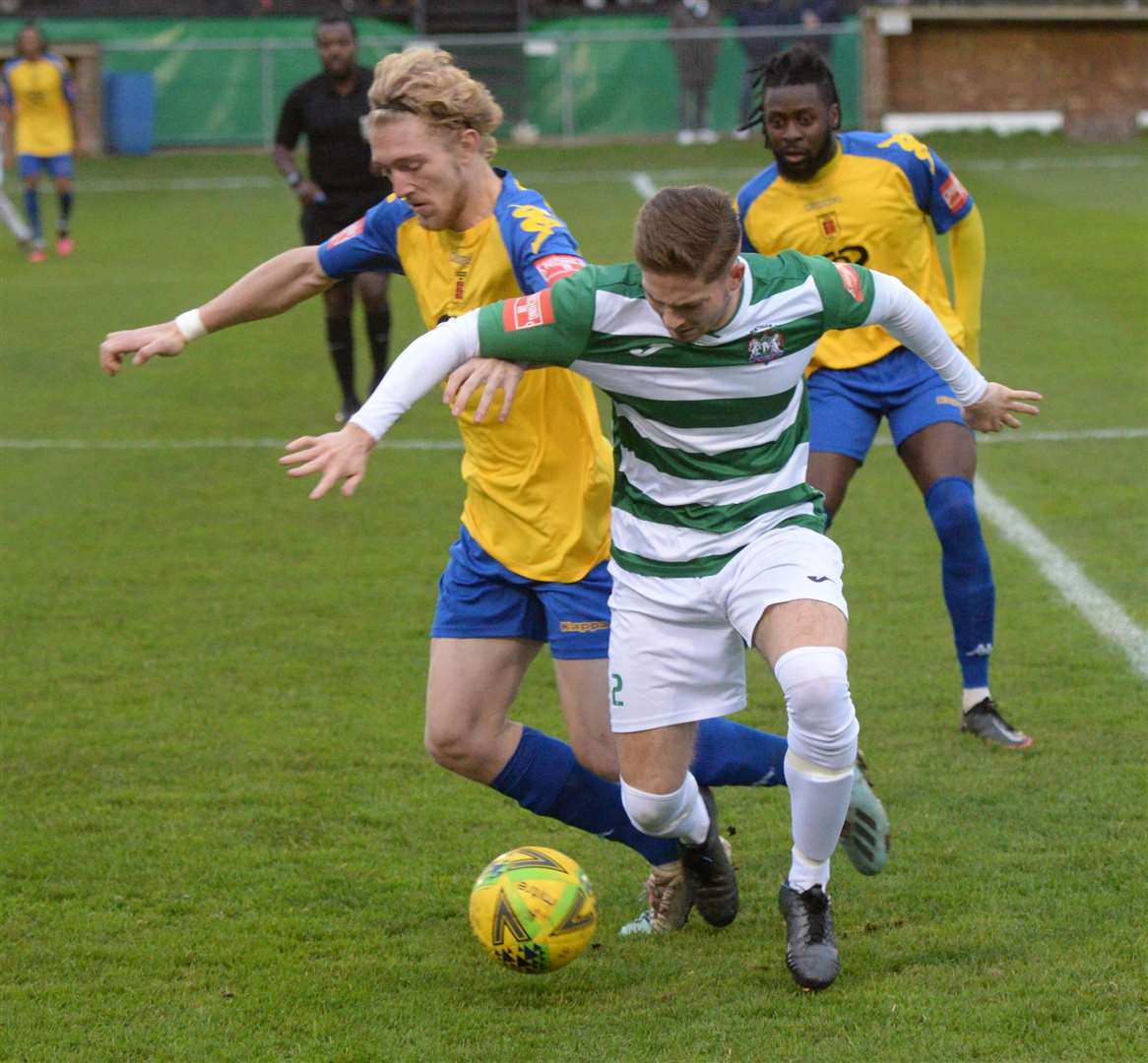 Town defender Charlie Dickens gets stuck on Saturday. Picture: Chris Davey