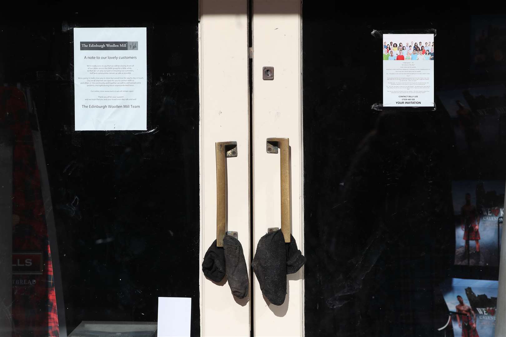 A notice on the door of a closed Edinburgh Woollen Mill shop in Princes Street, Edinburgh (Andrew Milligan/PA)