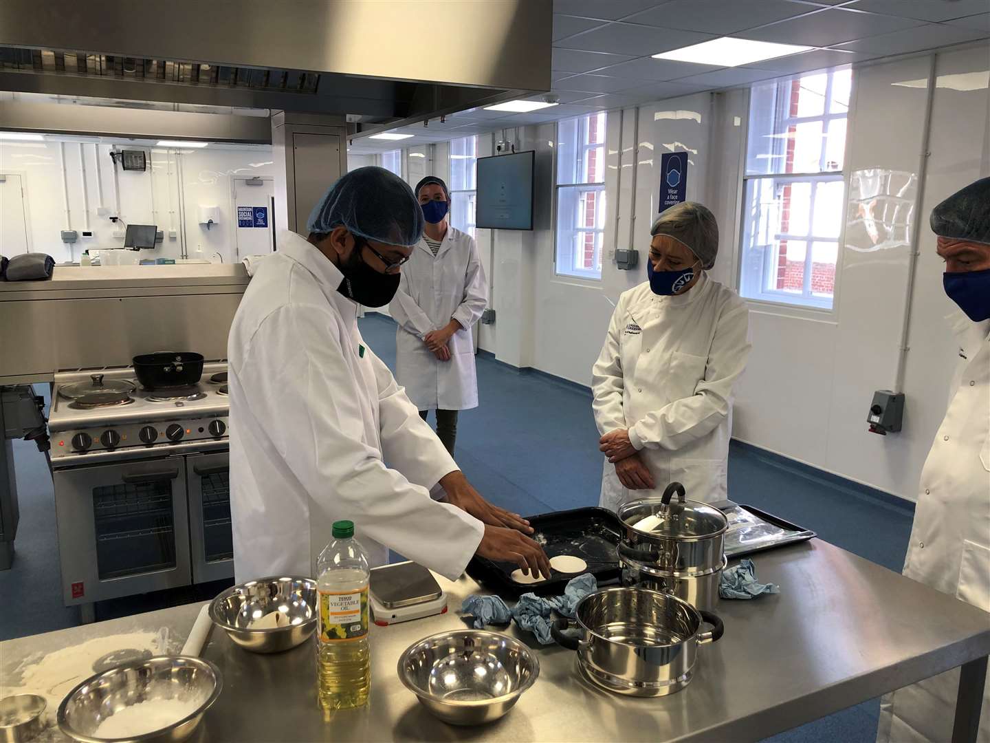 From left: Student, Vijesh Vikraman, prepares food made from cassava in new food product development lab. Picture: University of Greenwich