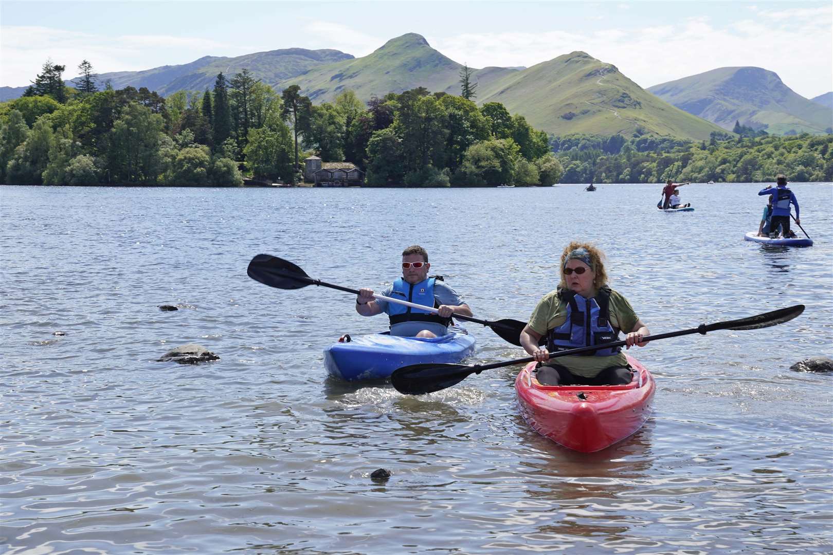 People enjoy the weather at Derwentwater in the Lake District National Park (Owen Humphreys/PA)