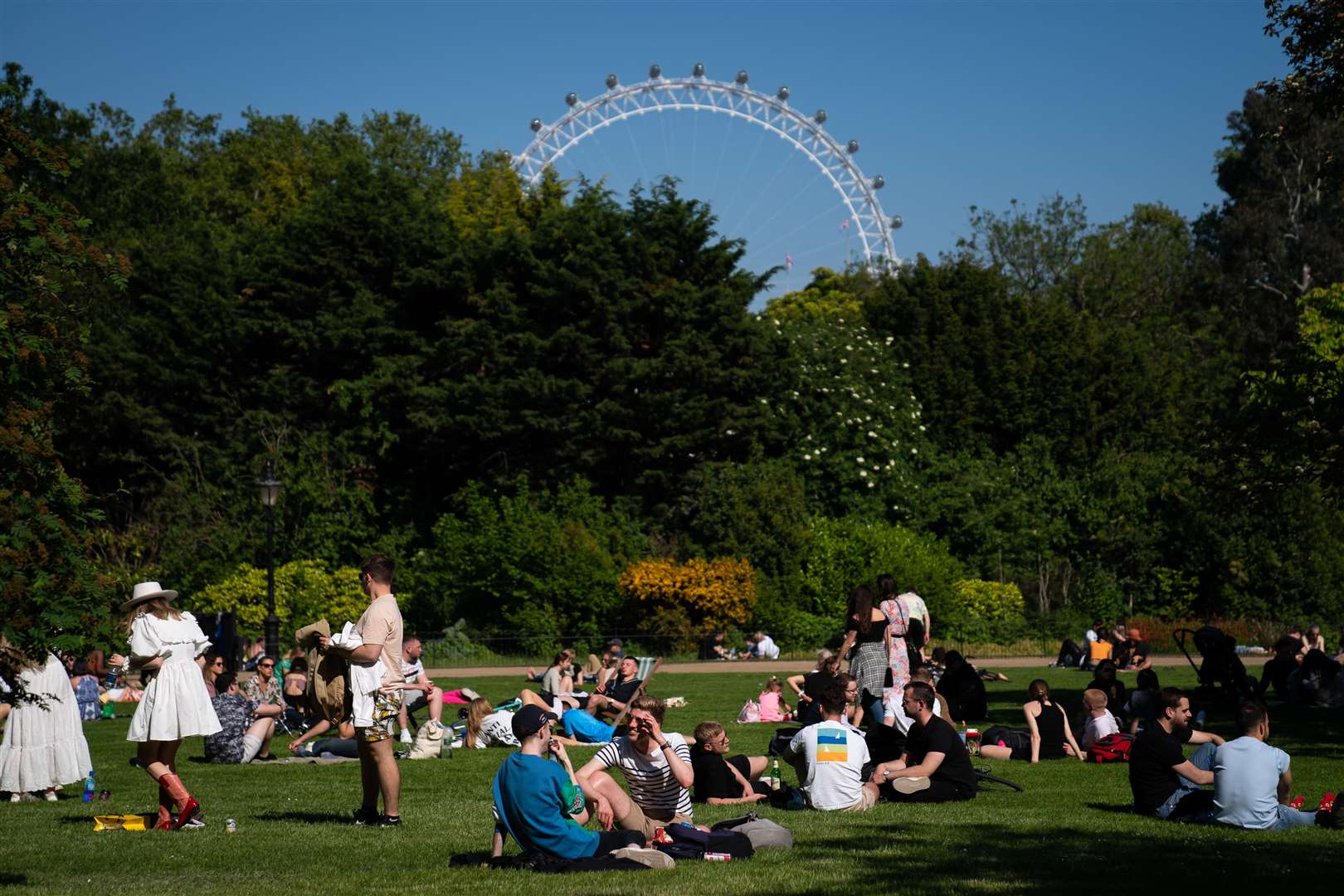 People relaxing in a park (Aaron Chown/PA)