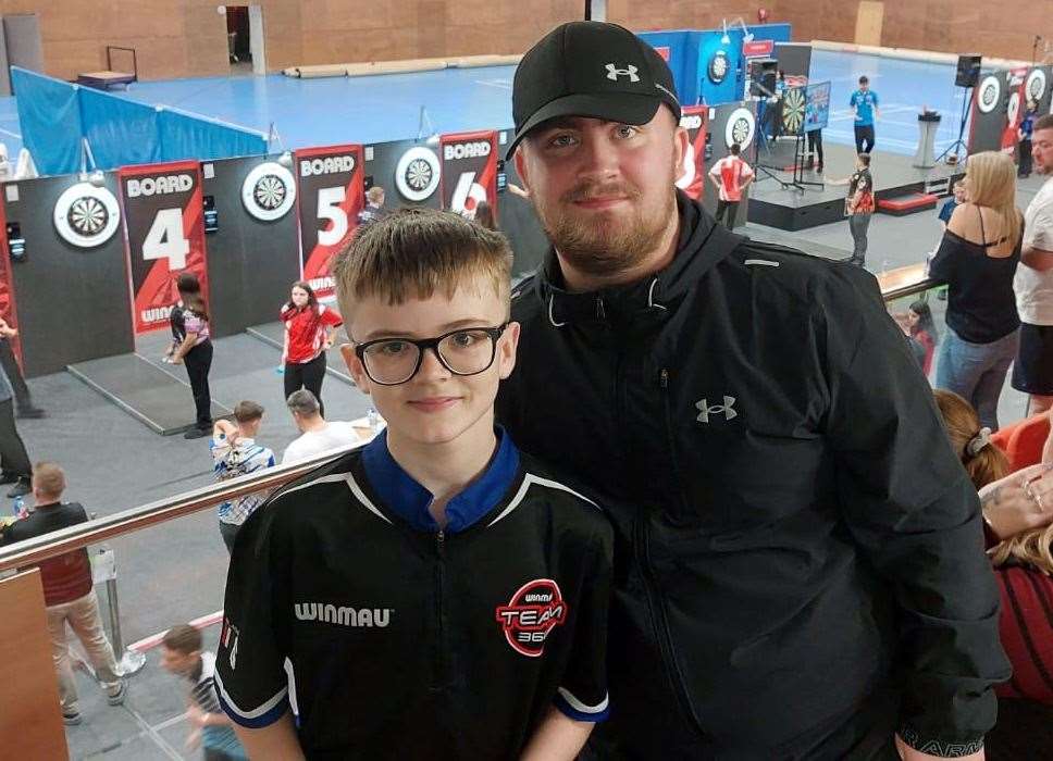 Young darts player Drake Porter, from Sheerness, pictured with Luke Littler at the JDC World Darts Championships in Gibraltar