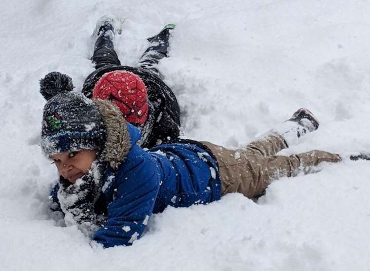 Two boys enjoying the snow in Rochester. Picture: @SiDeards