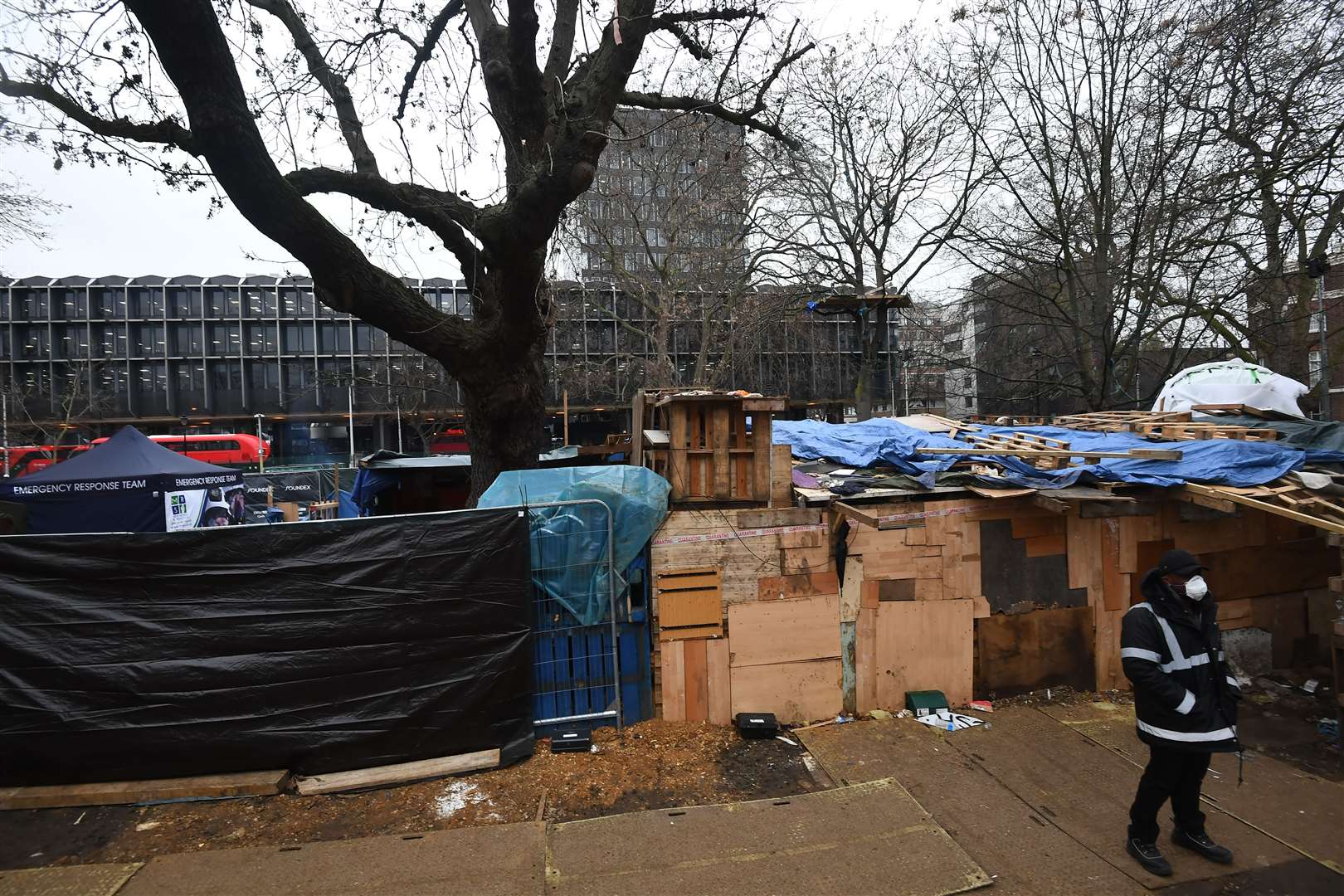 A security guard stands next to what remains of the anti-HS2 camp at Euston Square Gardens (Victoria Jones/PA)