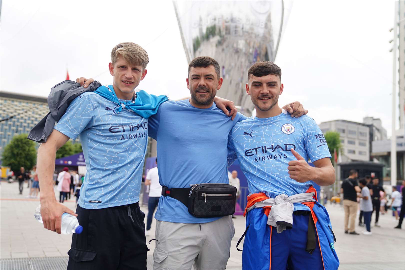 Manchester City fans Will Hustler, Stephen Cavanagh, and his son Dillion Cavanagh in Taksim Square, Istanbul (James Manning/PA)