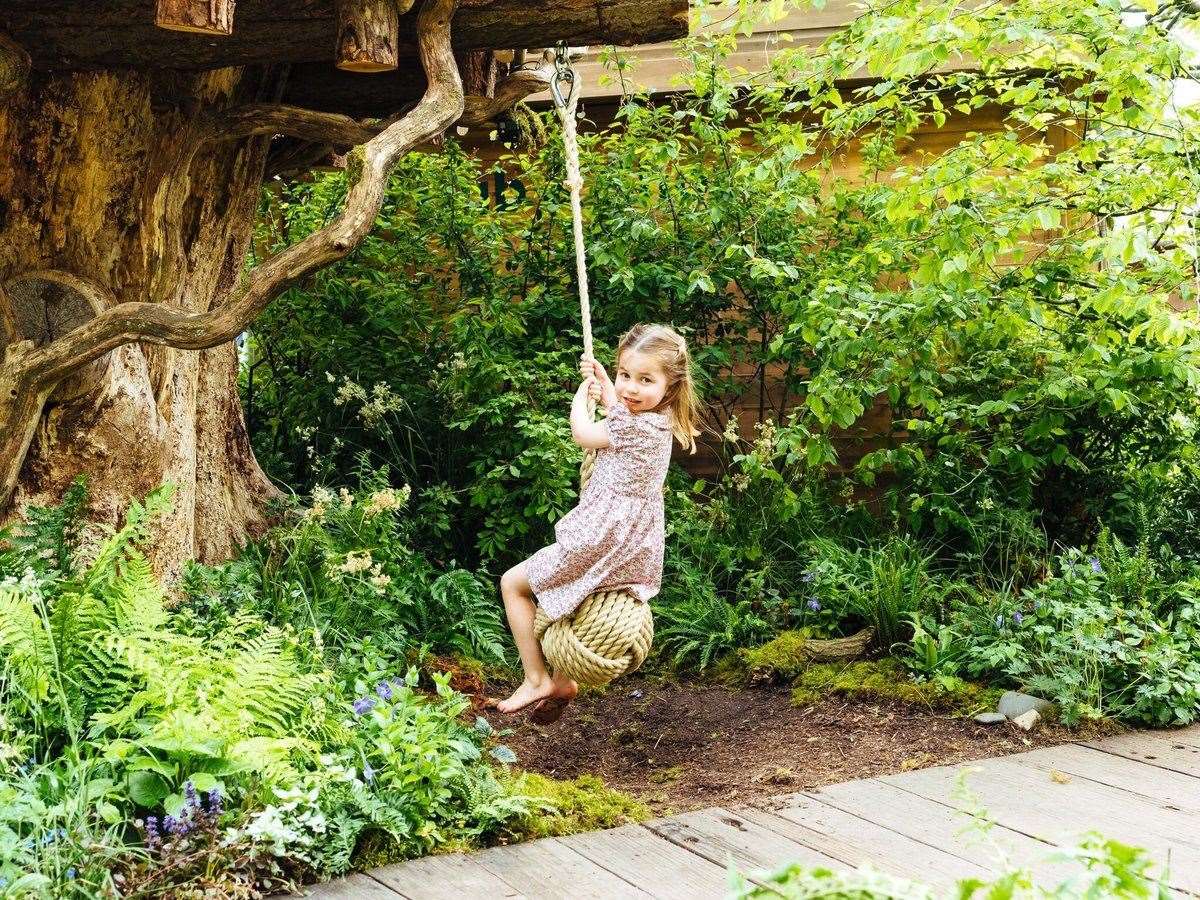 Princess Charlotte enjoys the rope swing in the garden designed by her mother at the RHS Chelsea Flower Show. Picture: Kensington Palace. (11504223)