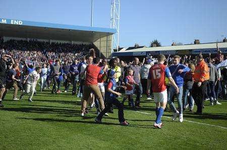 Gills' fans invade the pitch as they celebrate winning the championship
