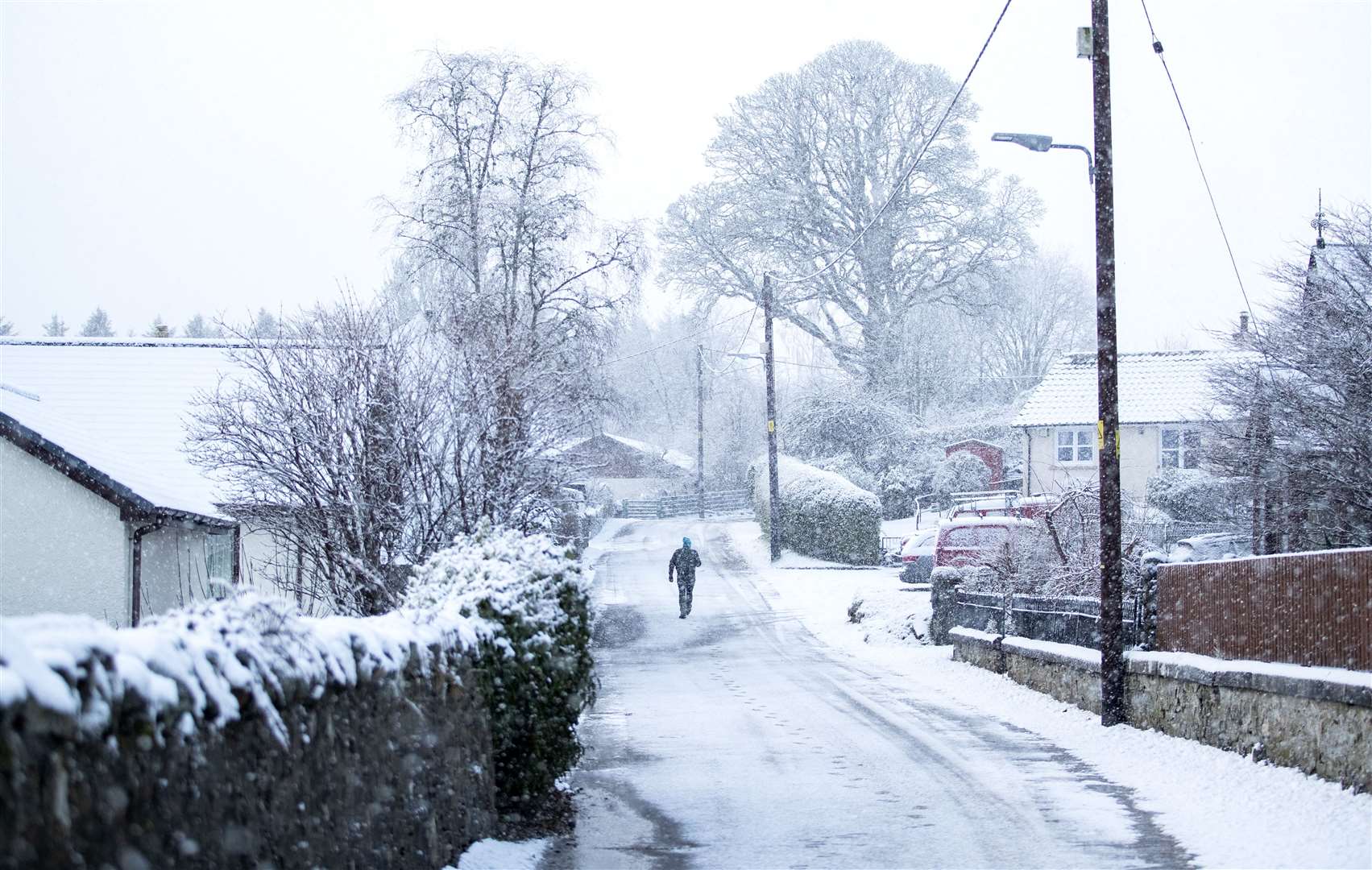 A man walks through the snow in Killin, Stirlingshire (Jane Barlow/PA)