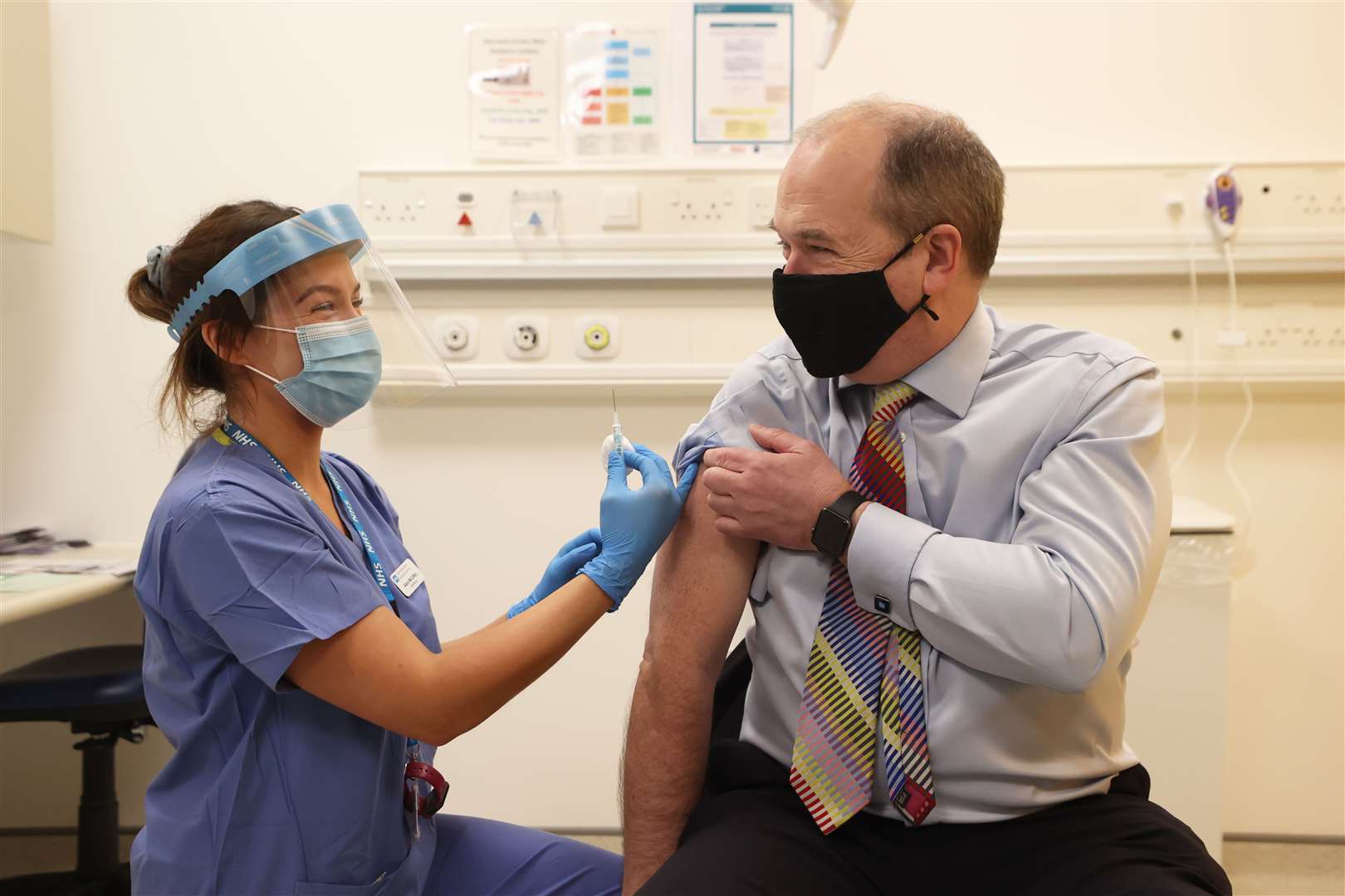 Northern Ireland Chief Medical Officer Sir Michael McBride receiving his first dose of the Oxford/AstraZeneca coronavirus vaccine from nurse Alana McCaffery at the Ulster Hospital in March (Liam McBurney/PA)