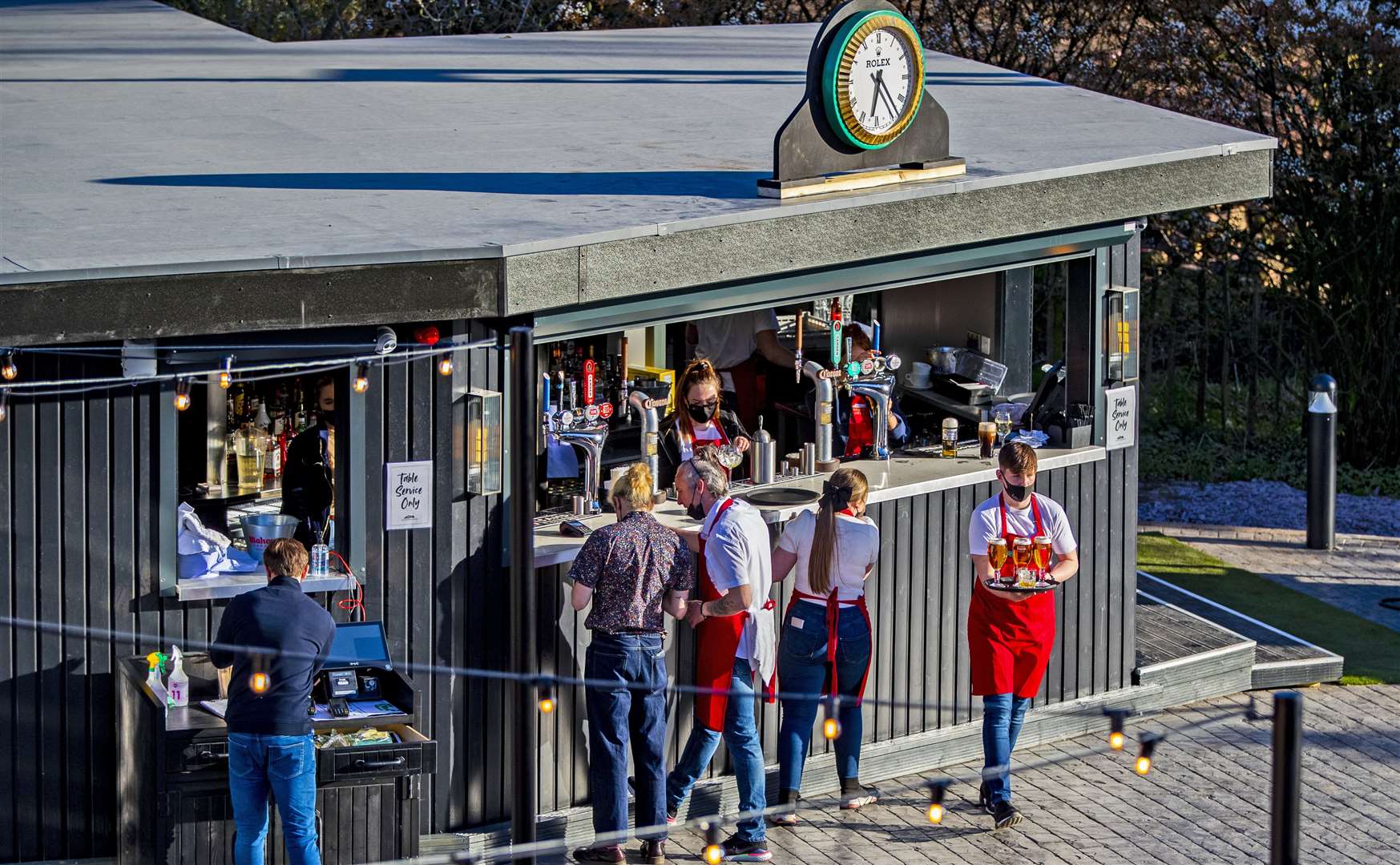 Staff at the bar of Allerton Manor golf course’s new outdoor 250 seater beer garden (Peter Byrne/PA)