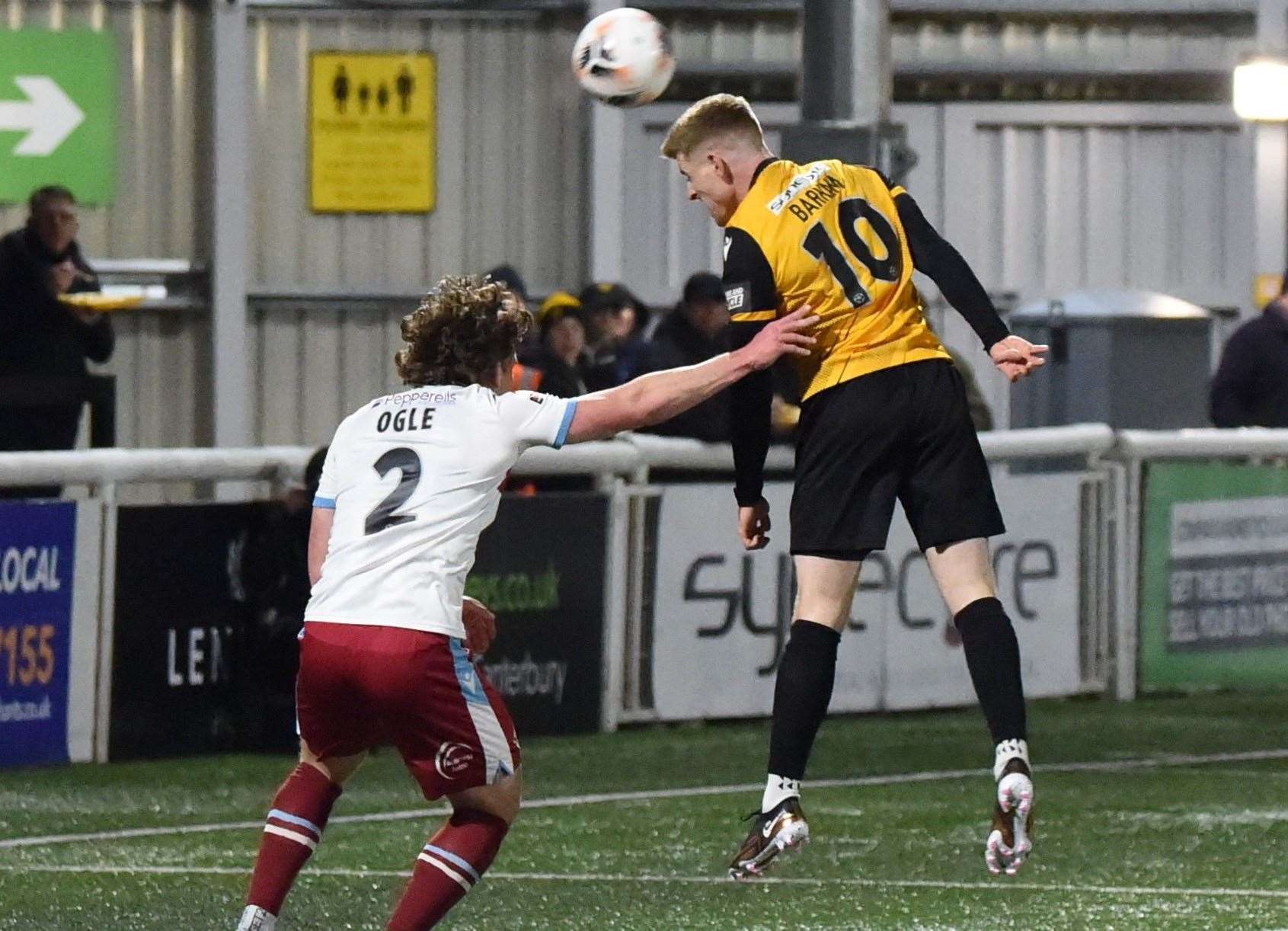 Maidstone striker Jack Barham tries to head for goal ahead of away defender Reagen Ogle. Picture: Steve Terrell