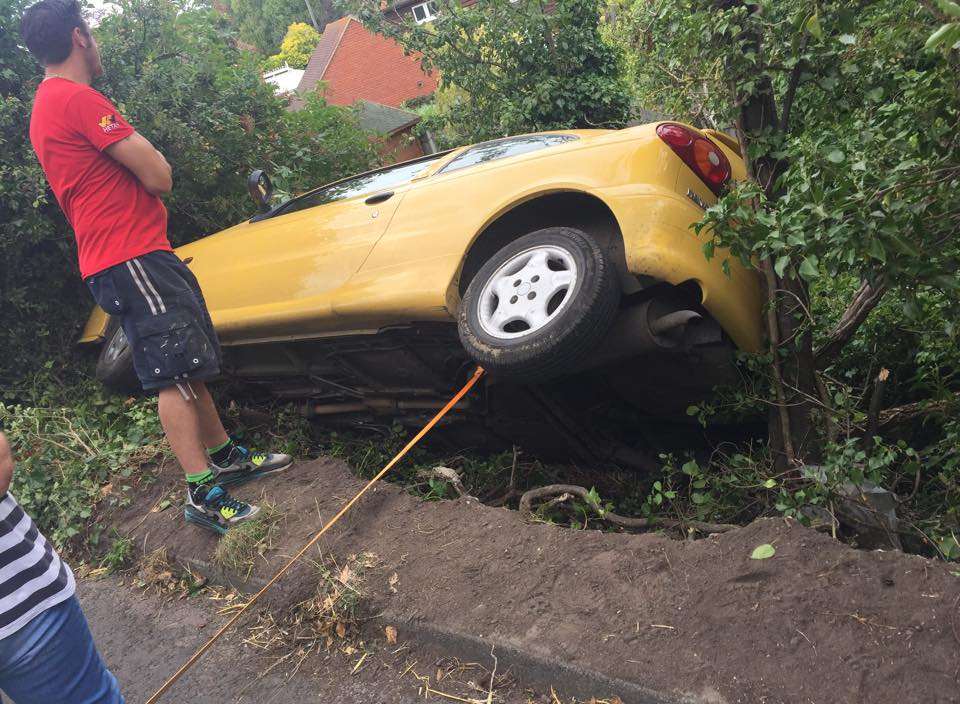 The car hangs over a 10 foot drop