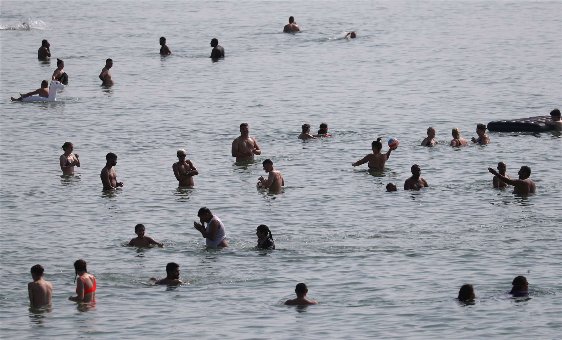 Cooling off in the sea (Andrew Matthews/PA)