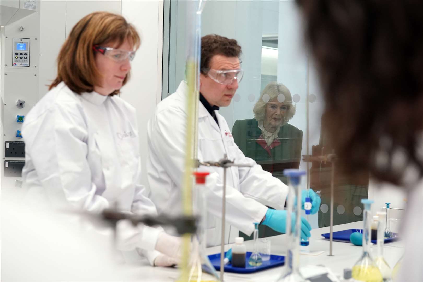 The Queen Consort, rear, viewed the lab (Andrew Milligan/PA)